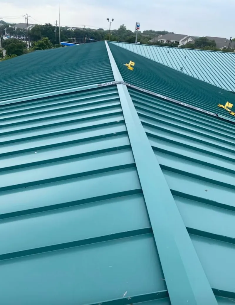 Green commercial metal roof ridge and valley for Metal Roof Repair in Bastrop